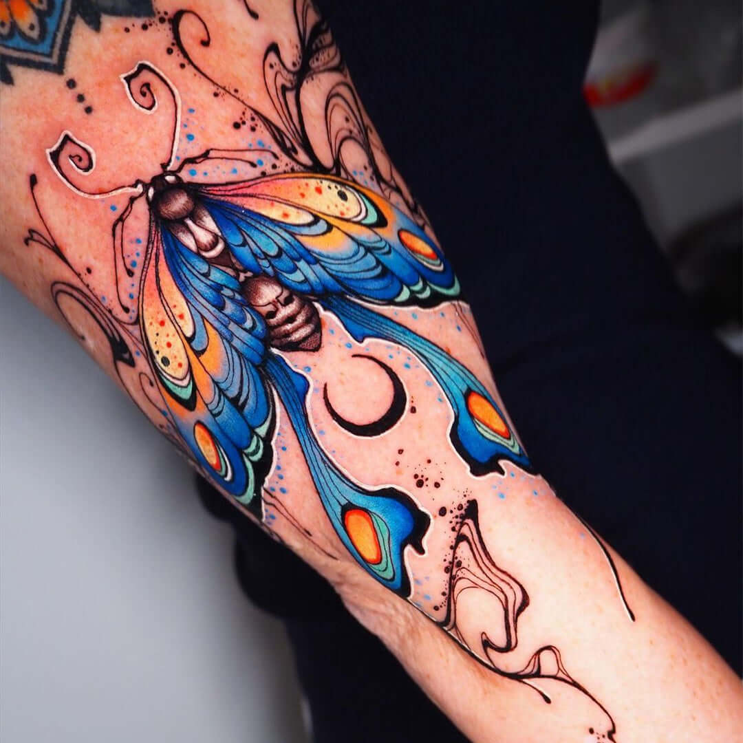 Colorful moth tattoo on arm by Emalla Eliot Cartridge Needles