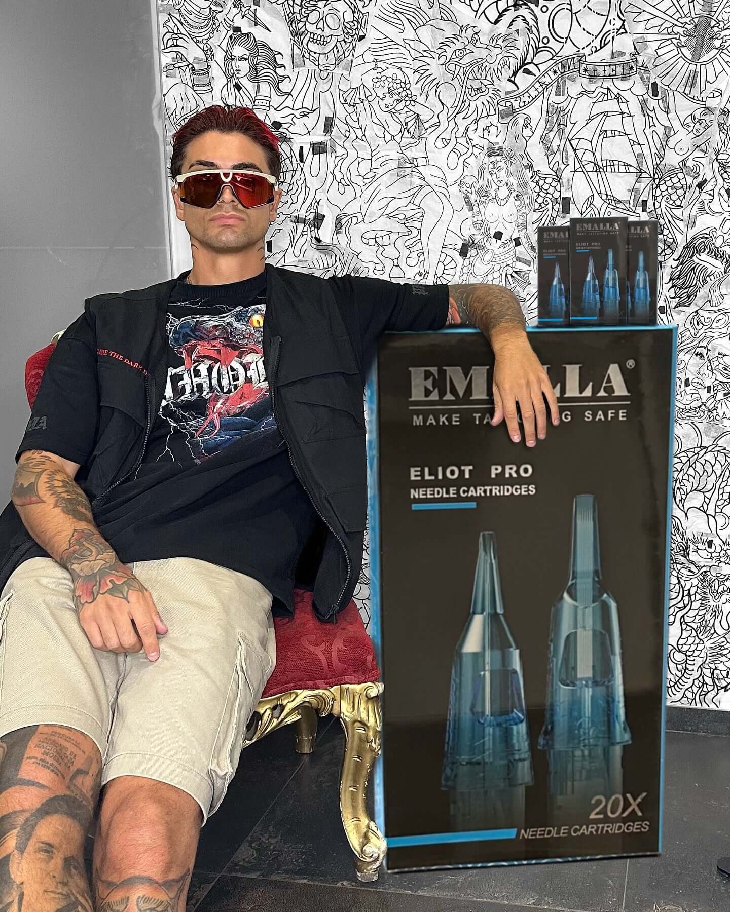 Artist Andrea Veronesi leans confidently against a giant box of Emalla Eliot Pro cartridges.