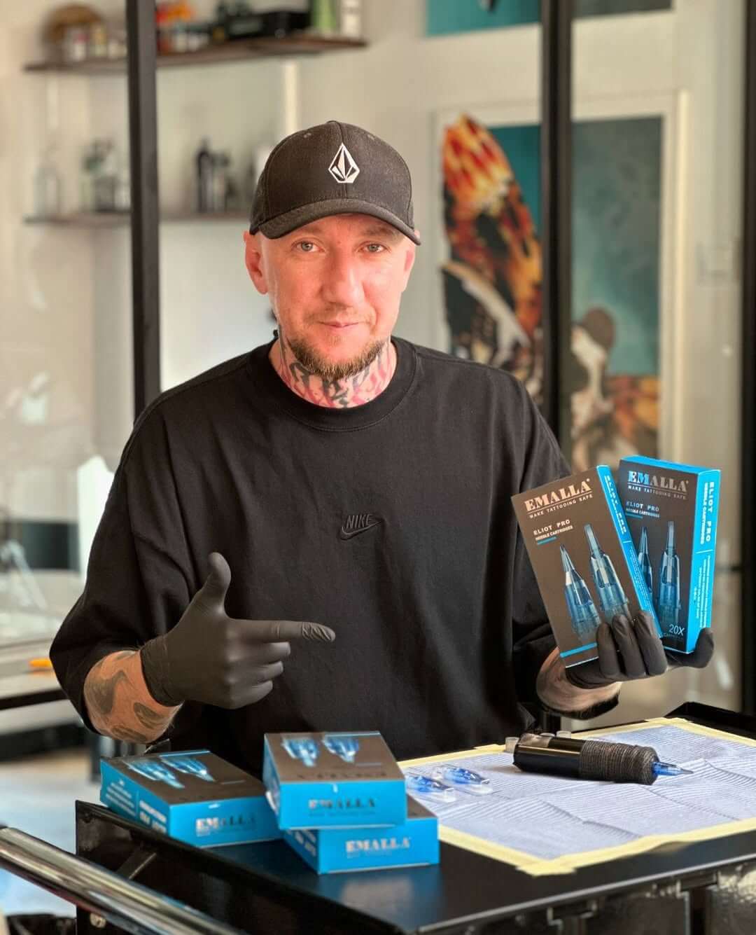 In a bright, modern tattoo studio, an artist prepares the Emalla Eliot Pro for a session.