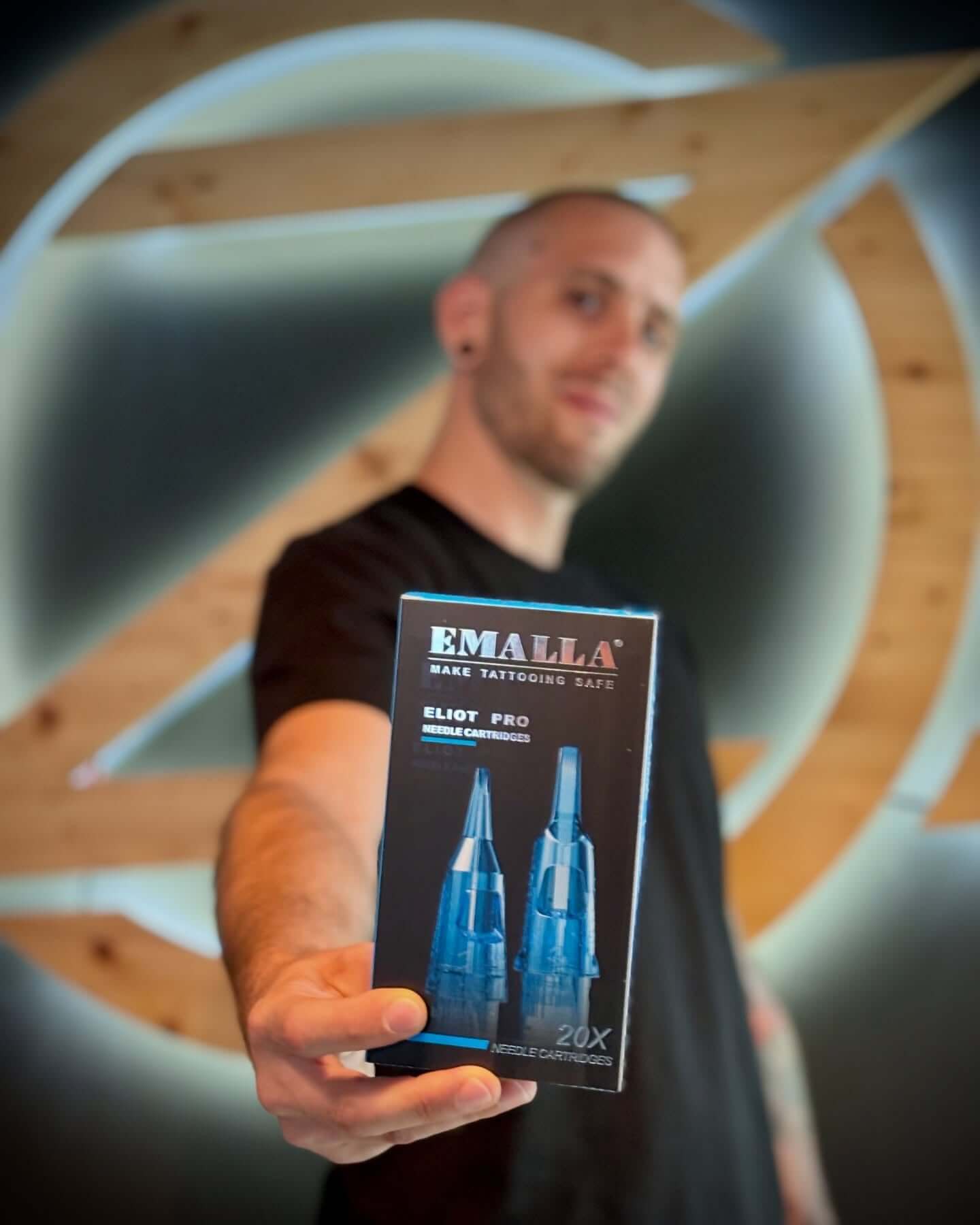 Professional tattoo artist Roman Sunico proudly showcases Emalla Eliot Pro cartridges.