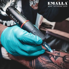 A tattooist from EMALLA Pro Team is tattooing with EMALLA EAGE Wireless Tattoo Pen Machine and Emalla cartridge needles